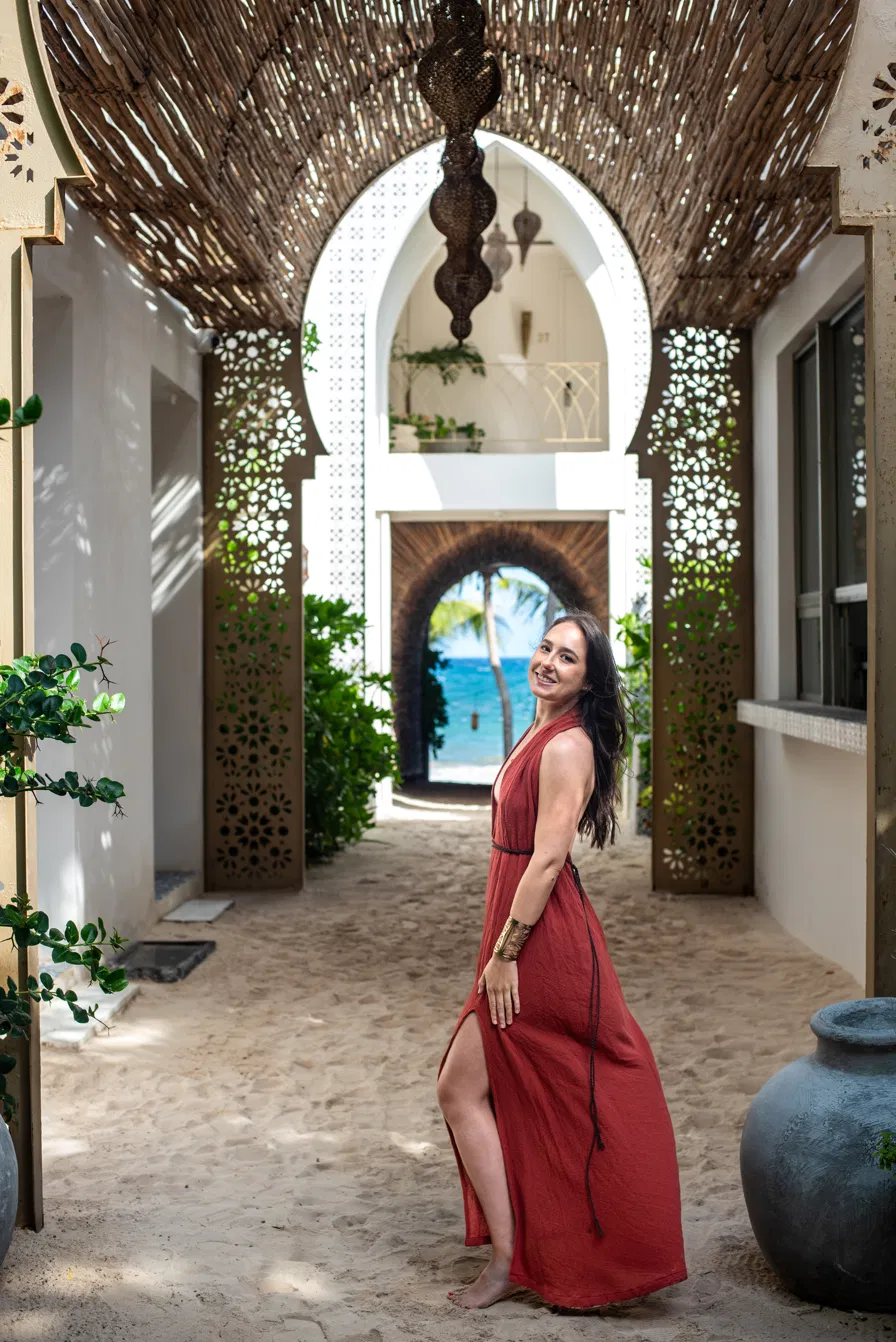 Gabriela walking through a Moroccan-style archway